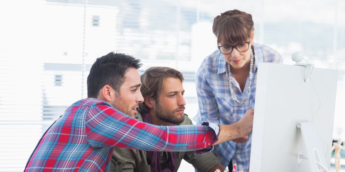 Equipo de trabajadores observando un ordenador